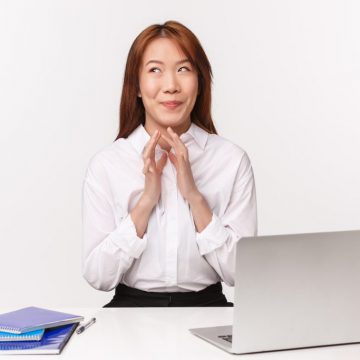 Career, work and women entrepreneurs concept. Close-up portrait of pleased sly asian woman smiling satisfied as dreaming about vacation, lots of money she earn on retail, steeple fingers scheming