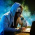 Hooded computer hacker stealing information with laptop