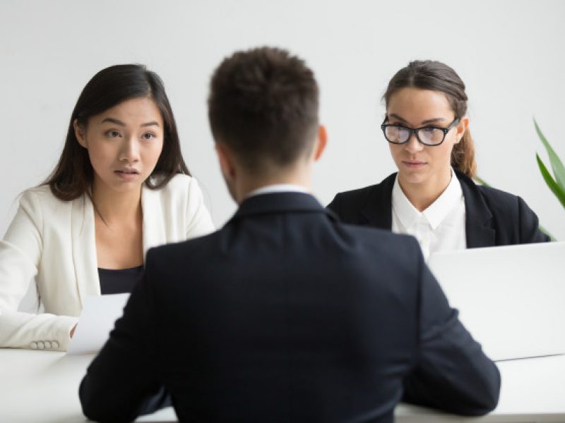 serious-unconvinced-diverse-hr-managers-interviewing-male-job-applicant_1163-4675